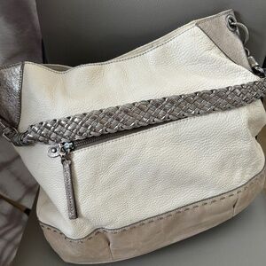 The Sak INDIO Hobo bag in cream pebble leather with tan and silver braided strap